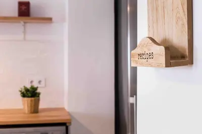 a wooden sign on the door of a refrigerator at Cozy apartment Valencia city center! in Valencia