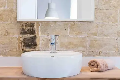 a white sink on a wooden counter in a bathroom at Cozy apartment Valencia city center! in Valencia