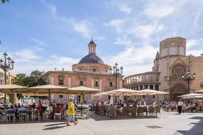 a group of people sitting at tables in front of a building at Cozy apartment Valencia city center! in Valencia