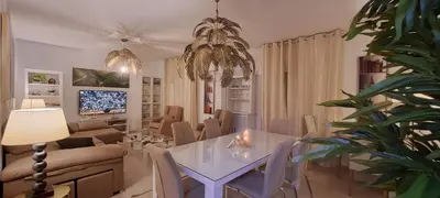 a living room with a dining table and a living room with a couch at Apartamento Romero Valencia in Benicull