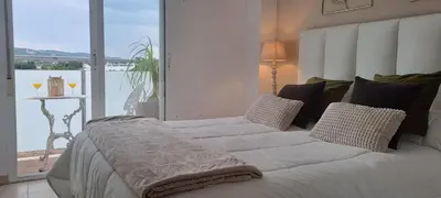 a bed with white sheets and pillows in a bedroom at Apartamento Romero Valencia in Benicull
