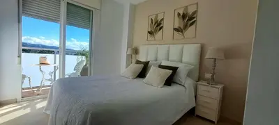 a bedroom with a large bed and a large window at Apartamento Romero Valencia in Benicull