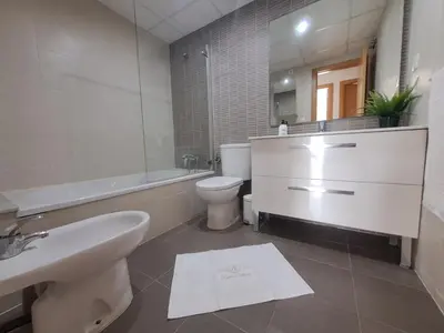 a bathroom with a sink and a toilet and a tub at Apartamento Romero Valencia in Benicull
