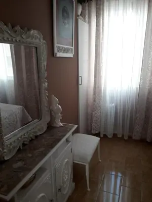 a room with a mirror and a chair and a window at Carrer Roma in Sagunto