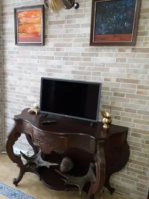 a wooden table with a television on a wall at Carrer Roma in Sagunto
