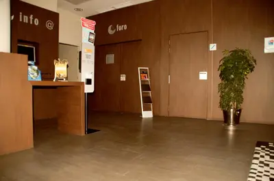 a lobby with a desk and a potted plant at Hotel AS Torrent in Torrent