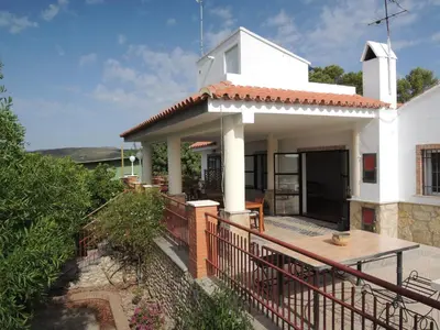 a white house with a porch and a deck at Finca Mirador in Macastre