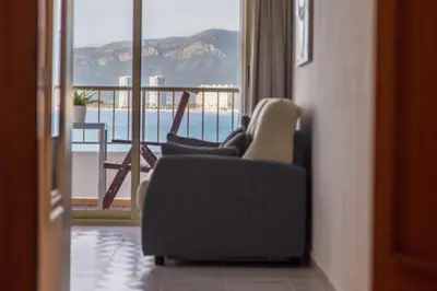 a room with two chairs and a balcony with a view at Los Olivos Apartment Cullera in Cullera