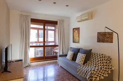 a living room with a blue couch and a television at FLORIT FLATS - Apartment Torres de Quart I in Valencia