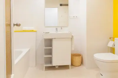 a white bathroom with a sink and a toilet at FLORIT FLATS - Apartment Torres de Quart I in Valencia