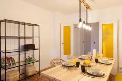 a dining room with a wooden table and chairs at FLORIT FLATS - Apartment Torres de Quart I in Valencia