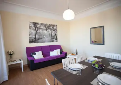 a living room with a purple couch and a table at SingularStays Seu Catedral in Valencia