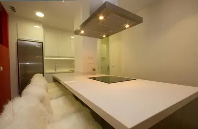 a kitchen with a counter with a white counter top at Total Valencia Elegance in Valencia