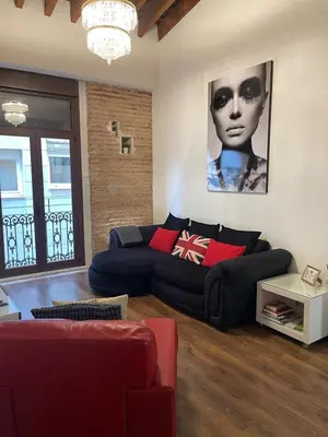a living room with a black couch and red pillows at Total Valencia Elegance in Valencia