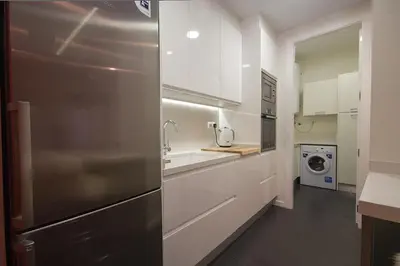 a kitchen with white cabinets and a stainless steel refrigerator at Total Valencia Elegance in Valencia