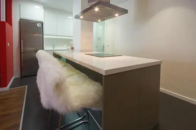 a kitchen with a island with a white counter top at Total Valencia Elegance in Valencia