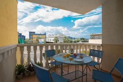 a patio with a table and chairs on a balcony at SingularStays Puzol Beach VII in Puzol