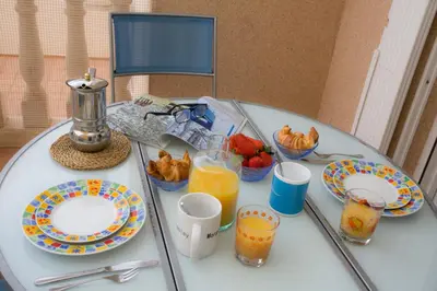 a glass table with plates of food and drinks on it at SingularStays Puzol Beach VII in Puzol