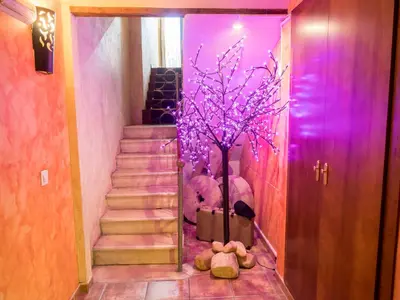 a hallway with a staircase with a tree and teddy bears at Valterra y Tosal in Torres-Torres