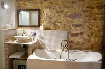 a bathroom with a bath tub and a sink at Valterra y Tosal in Torres-Torres