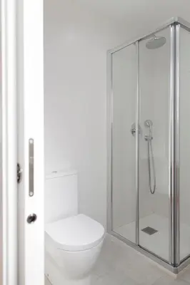 a bathroom with a toilet and a glass shower at FLORIT FLATS - Apartment Torres de Quart II in Valencia