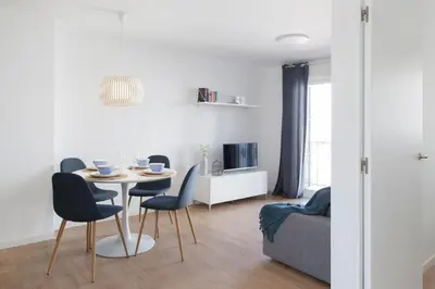 a living room with a table and chairs and a couch at FLORIT FLATS - Apartment Torres de Quart II in Valencia