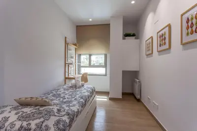 a bedroom with a bed and a window at ApartUP Patacona Select in Valencia