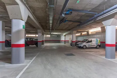 a parking garage with two cars parked in it at ApartUP Patacona Select in Valencia