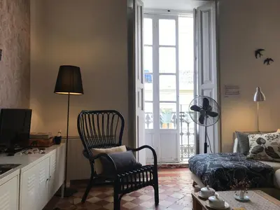 a living room with a chair and a couch at Appartement Elsa Valencia in Valencia