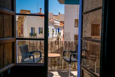 a view of a balcony with two chairs and a table at DOMUS Amabilis in Sagunto