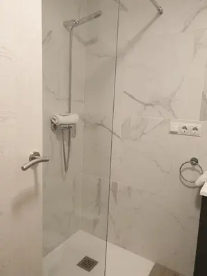 a bathroom with a shower with a glass door at Style Apartments Cabanyal Marina Beach in Valencia