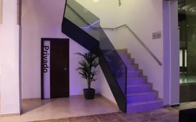 a purple staircase with a potted plant in a building at Hotel-Restaurante Casa Blava Alzira in Alzira