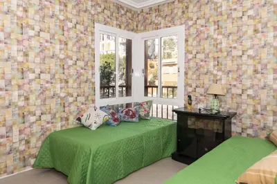 a bedroom with a green bed and a window at Nueva Vista 2º-4 in Cullera