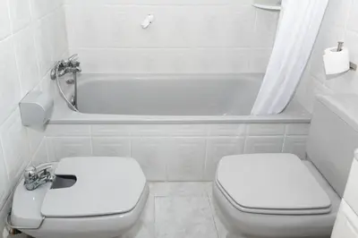 a white bathroom with a toilet and a bath tub at Nueva Vista 2º-4 in Cullera