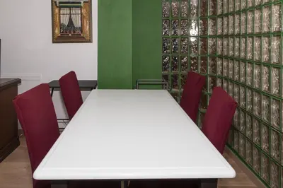 a white table and chairs in a room with green walls at Nueva Vista 2º-4 in Cullera