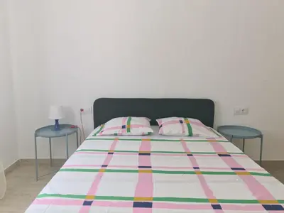 a bedroom with a bed with two blue tables at Campanar flat 2 in Valencia