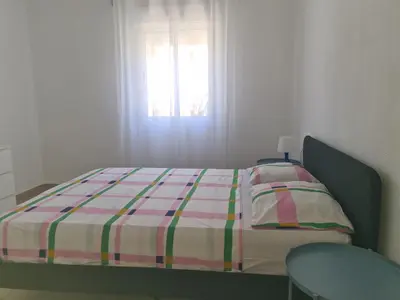 a bed in a bedroom with a window and a table at Campanar flat 2 in Valencia