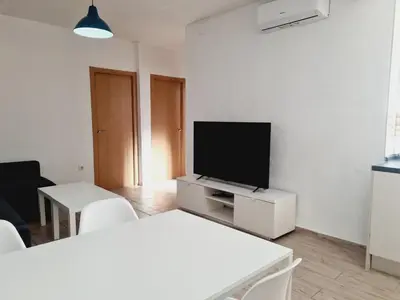 a living room with a flat screen tv on a white wall at Campanar flat 2 in Valencia