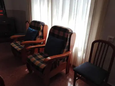 two chairs in a living room with a window at Casa Vall de Almonacid in Vall de Almonacid