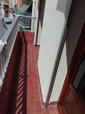 a brick walkway next to a building with a window at Casa Vall de Almonacid in Vall de Almonacid