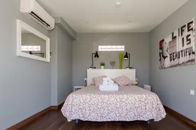 a bedroom with a bed with two teddy bears on it at Duplex Penthouse with terrace. Beach-Pool in Canet de Berenguer