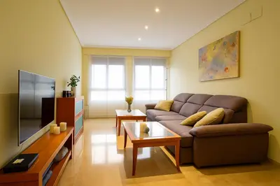 a living room with a couch and a tv at City Center Apartment in Valencia