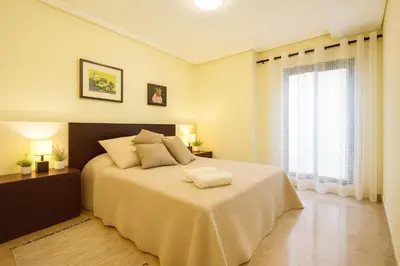 a bedroom with a large bed and a window at City Center Apartment in Valencia