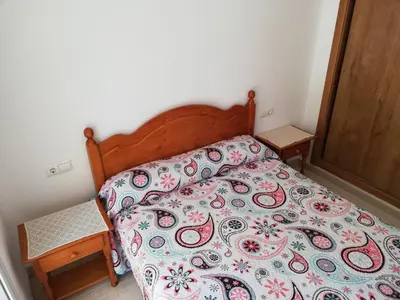 a bedroom with a bed with a colorful bedspread at Parquemar VIII Solo Familias Serviplaya in Playa de Xeraco