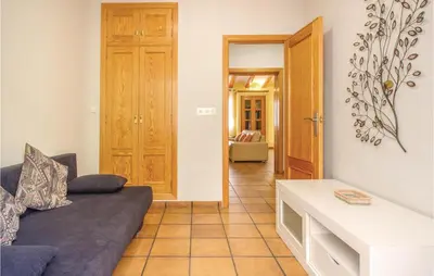 a living room with a couch and a table at 2 Bedroom Cozy Home In Faro De Cullera in Faro de Cullera