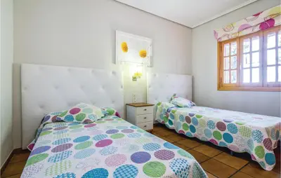 a bedroom with two beds and a window at 2 Bedroom Cozy Home In Faro De Cullera in Faro de Cullera