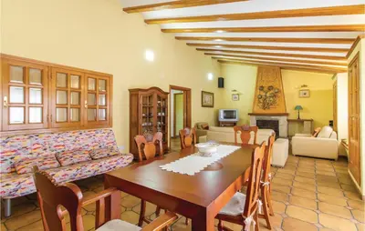 a living room with a table and a couch at 2 Bedroom Cozy Home In Faro De Cullera in Faro de Cullera