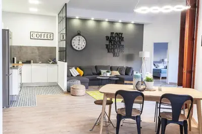 a kitchen and living room with a table and chairs at Plaza Redonda Center in Valencia