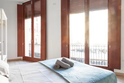 a bedroom with a bed with two towels on it at Plaza Redonda Center in Valencia