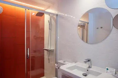 a bathroom with a shower and a sink and a mirror at Casual Socarrat Valencia - Adults Only in Valencia